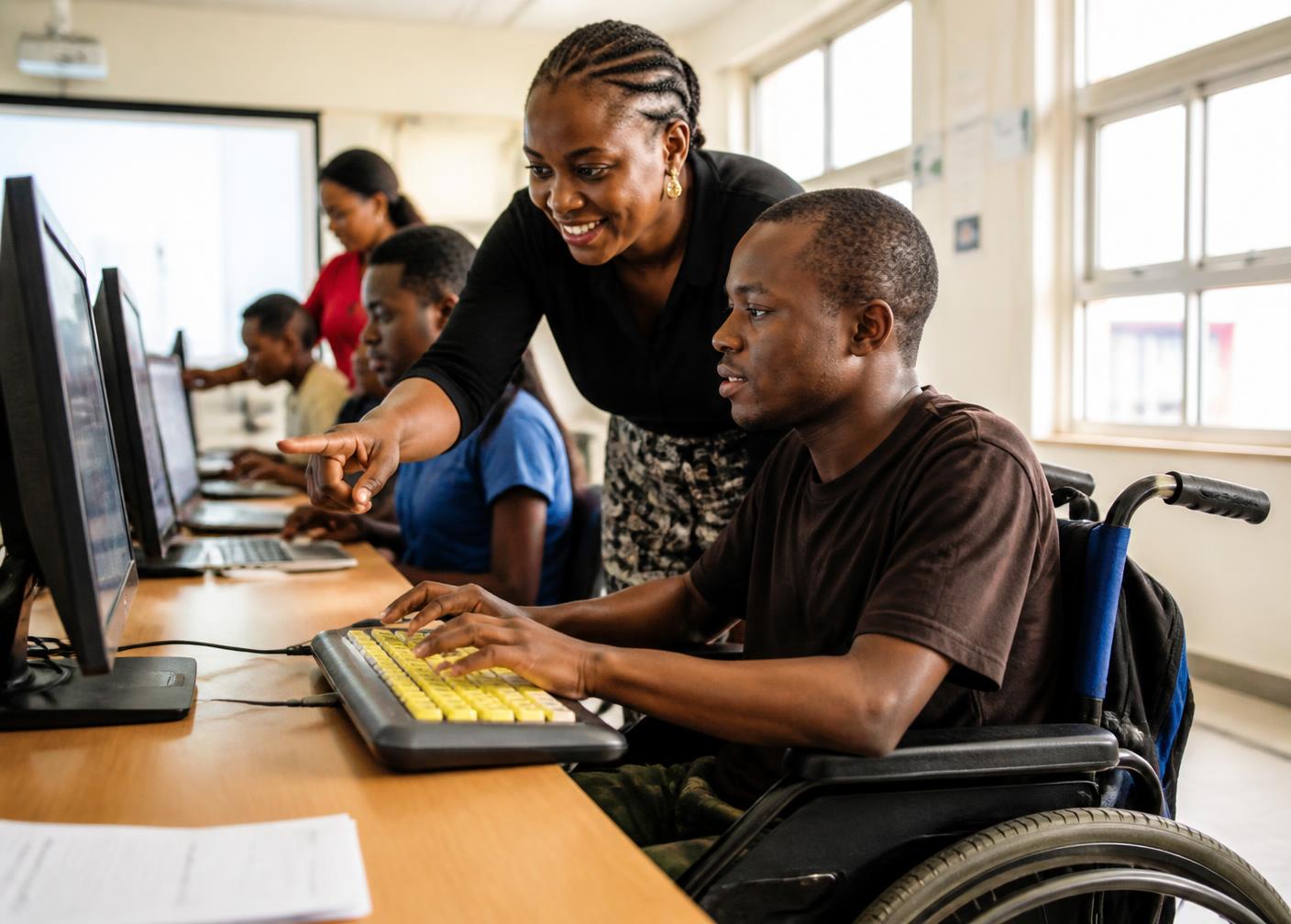 A young person with a disability learning computer skills